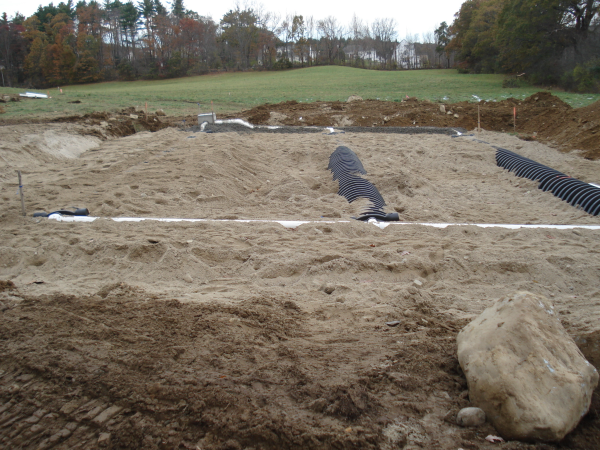 Custom home builder Southborough MA cover leach field with sand