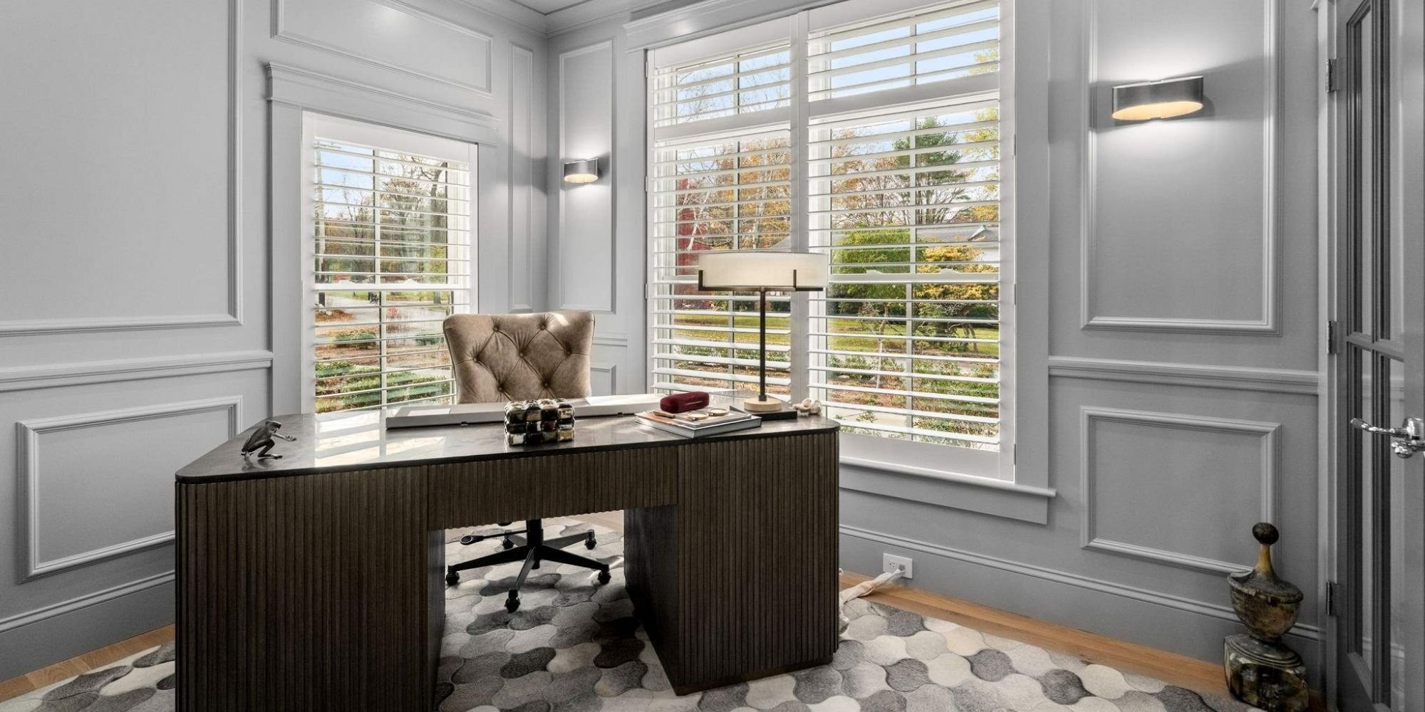 Custom home office in a custom home with large windows, gray walls, and custom trim details by Gilmore Building Co. in Grafton, MA