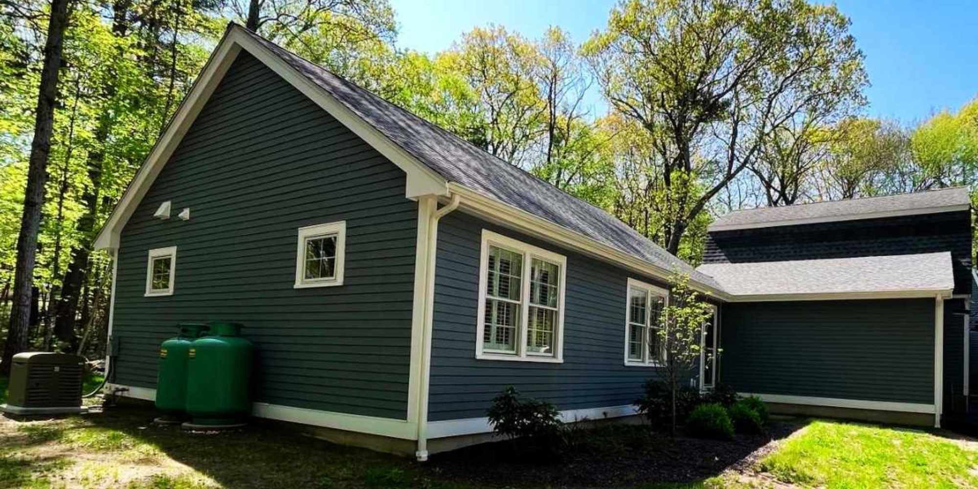 Photo of custom backyard ADU with modern siding and large windows in Boston MetroWest by Gilmore Building Co