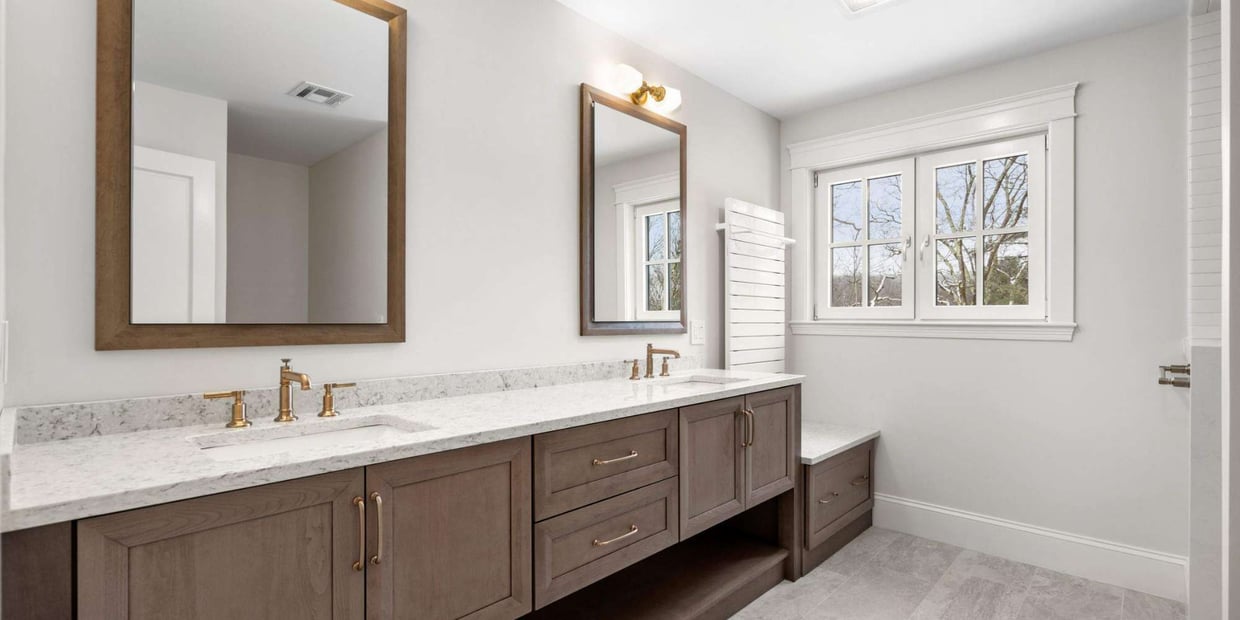 Bathroom remodel in Central MA by Gilmore Building Co. featuring dual sinks, modern fixtures, and bright, clean design