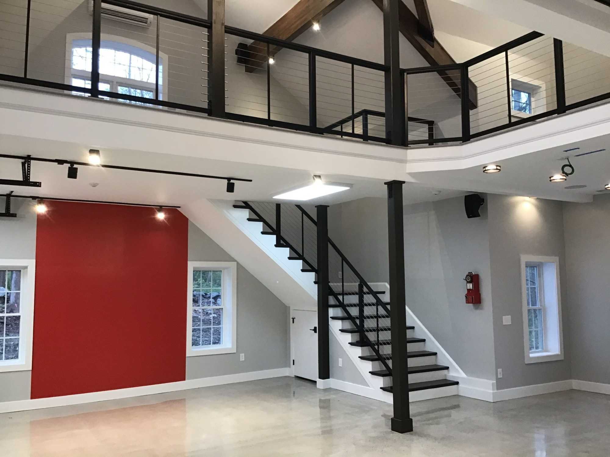 A custom workshop with an open level above the main floor in Auburn, MA by Gilmore Building Co.
