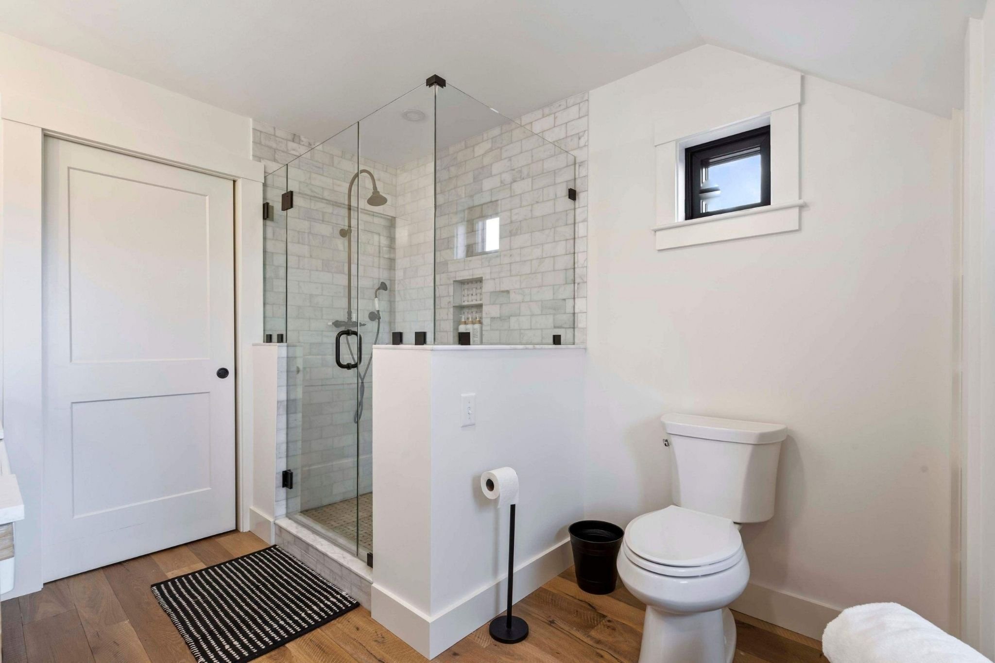 Custom bathroom in a Central Massachusetts whole home remodel with a large glass shower by Gilmore Building Co