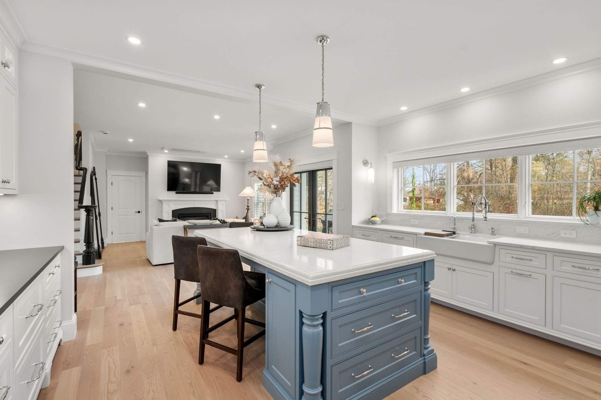Custom kitchen in a Grafton, MA whole home remodel with a large island and two-tone countertops by Gilmore Building Co