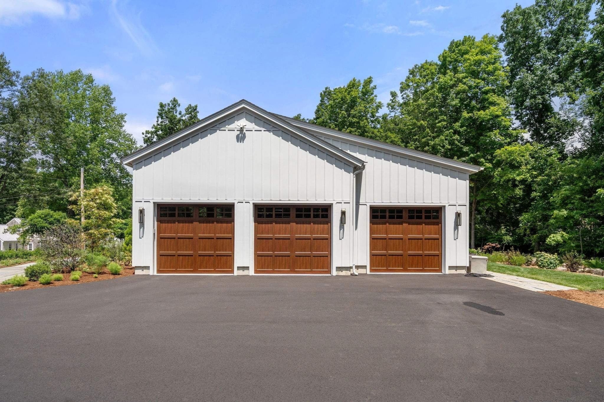 Three-car garage attached to a custom home in Grafton, MA by Gilmore Building Co