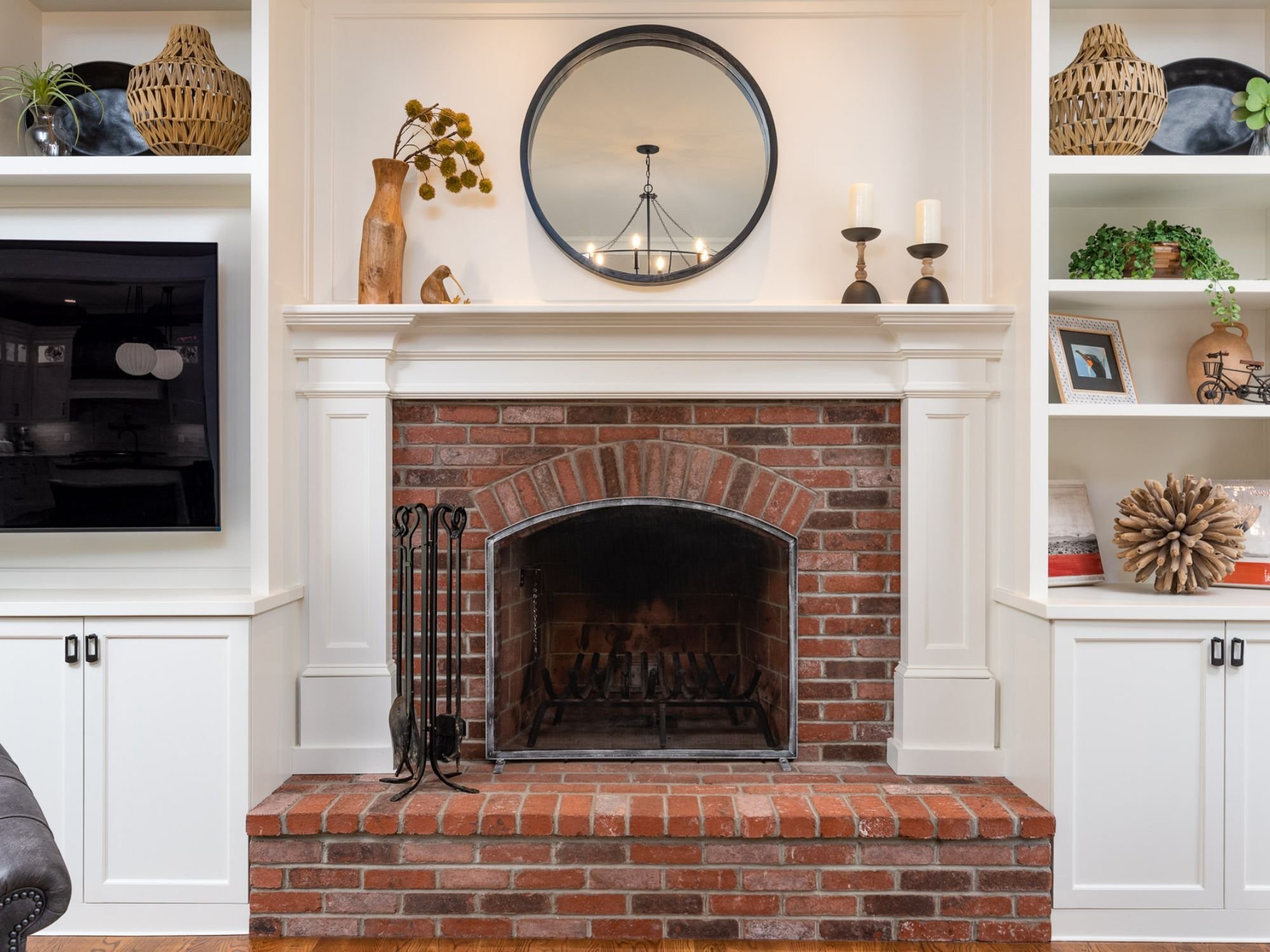 Whole home remodel featuring a fire place with a brick surround and custom millwork by GIlmore Building Co. in Westborough, MA