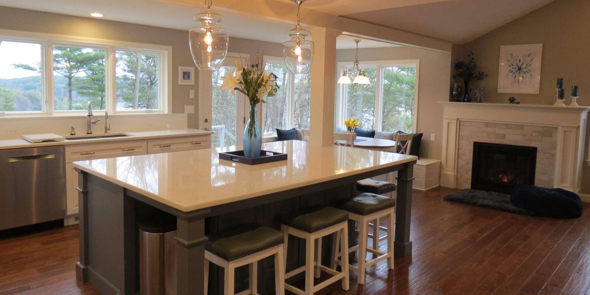 Image of a custom open-concept kitchen with dining nook and fireplace in Grafton, MA
