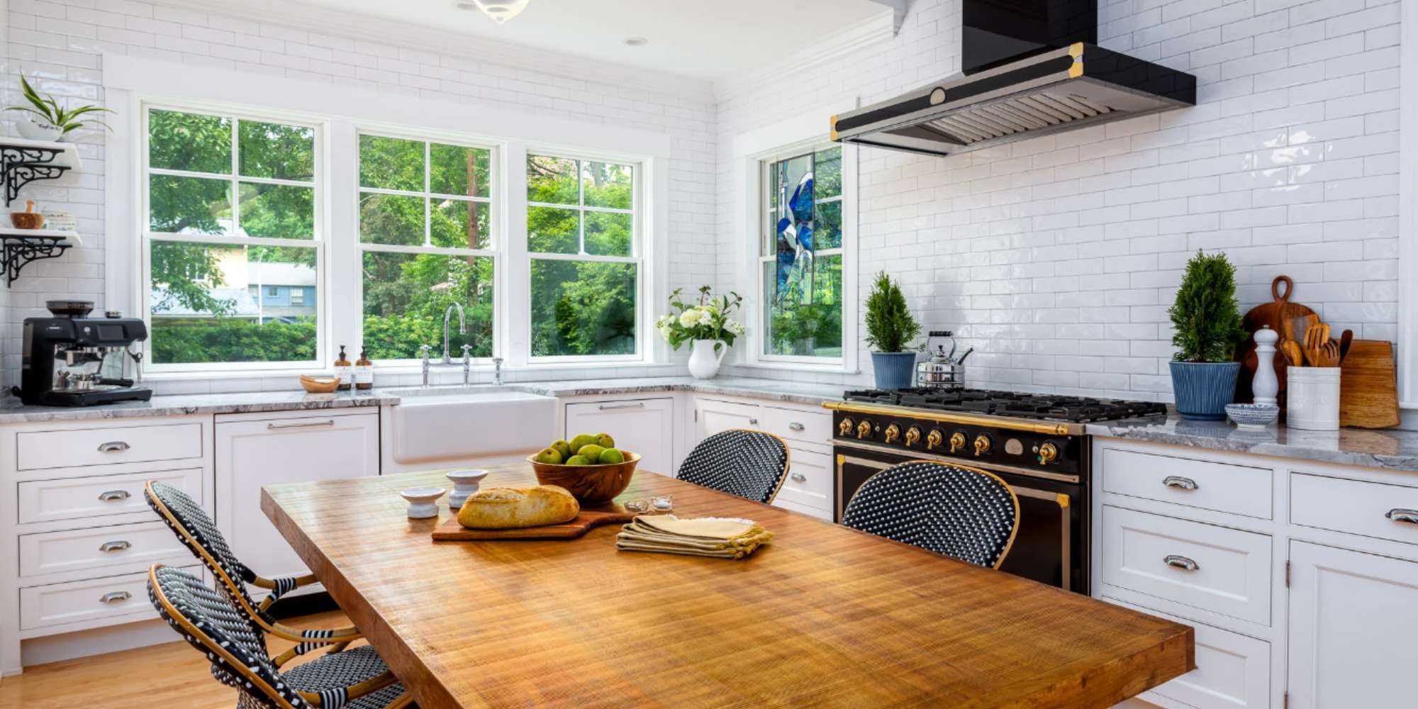 Image of a custom kitchen with gas range and gold features by Gilmore Building Co.